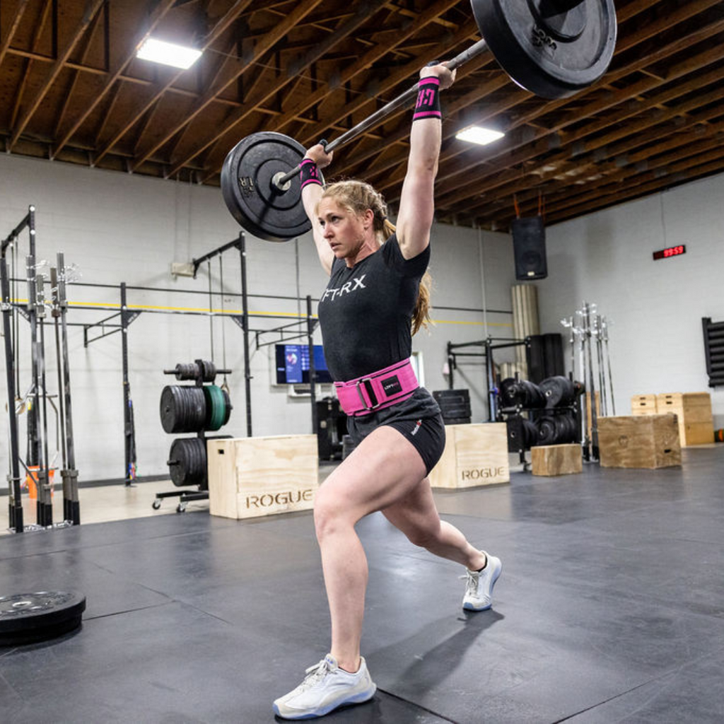 female athlete in pink belt lifting weights