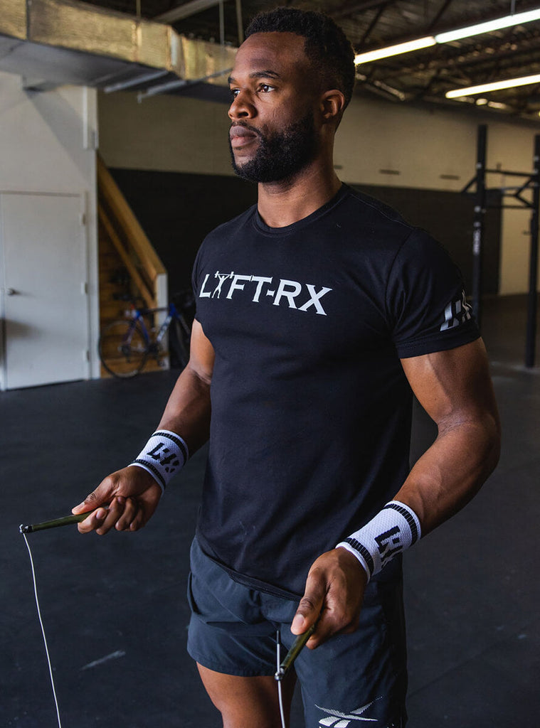 man wearing a lyftrx shirt holding a jump rope