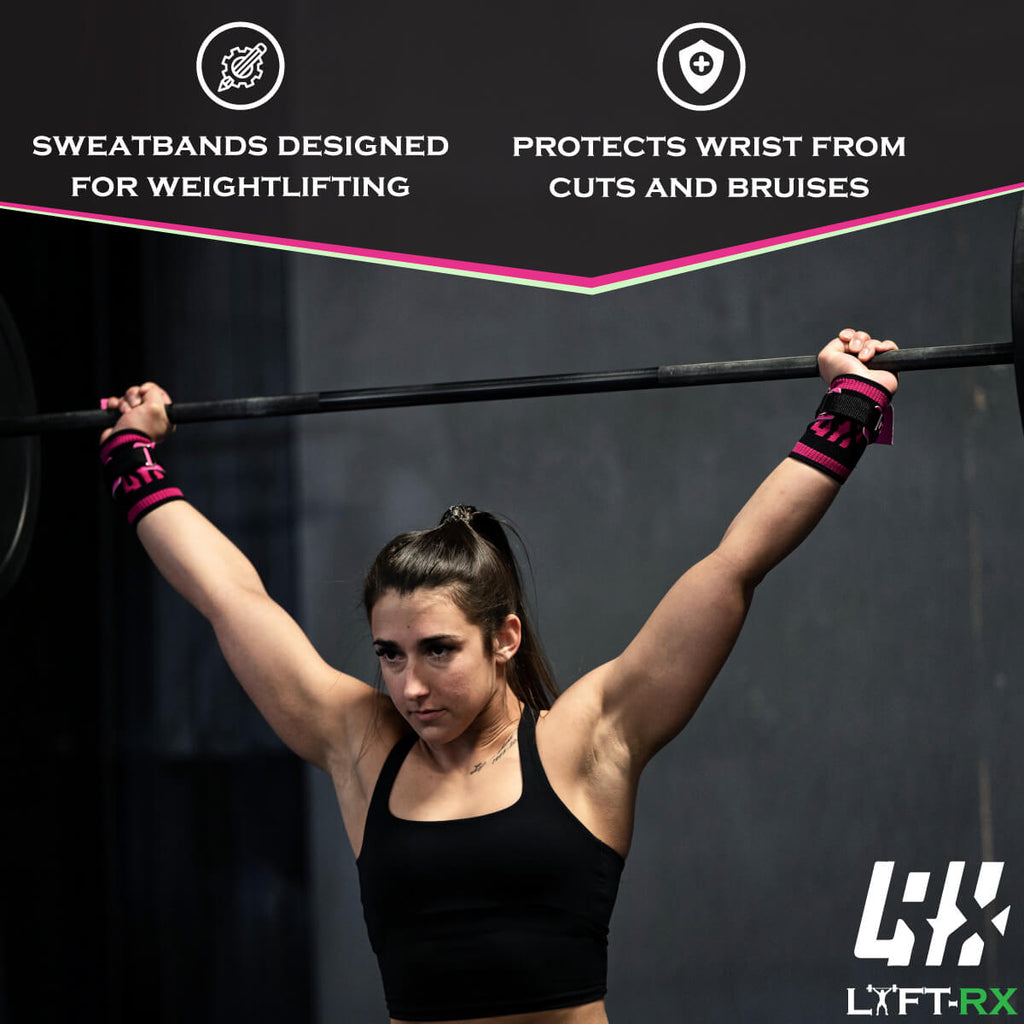 woman with pink wristbands holding a barbell overhead